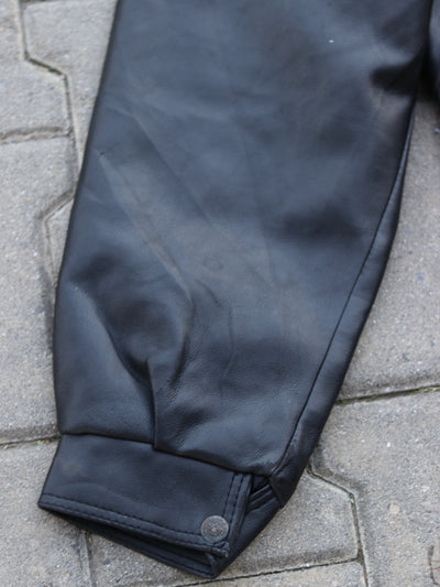 Black jacket sleeve and snap-fastening cuff detail