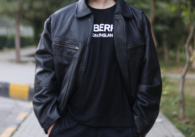 Black twin-zip jacket worn open by a model
