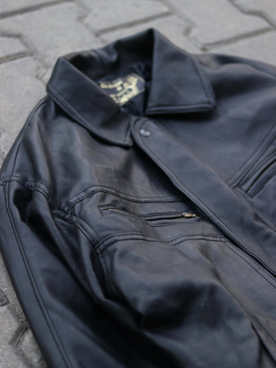 Close-up of black jacket chest zip pocket and panel stitching