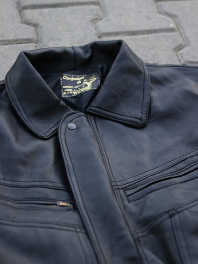 Black jacket collar, neck label and snap placket detail