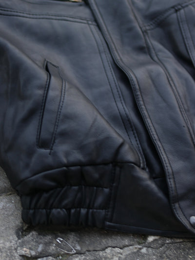 Black jacket lower pocket, panel seam and elasticated hem detail