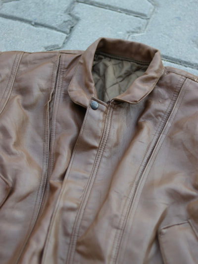 Close-up of brown jacket collar, panel stitching and quilted lining