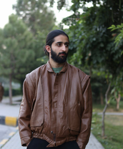 Brown removable-sleeve jacket worn by a model, front view