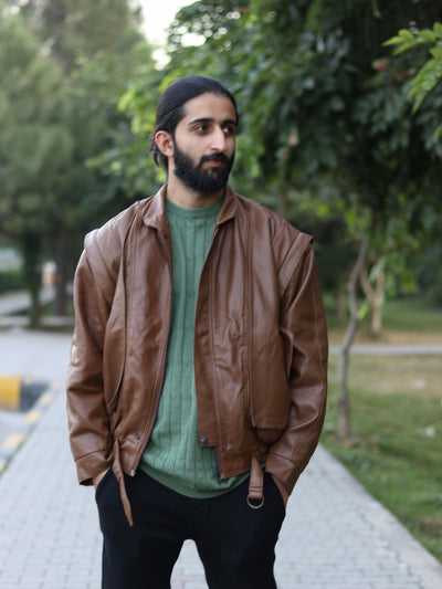 Brown removable-sleeve jacket worn open by a model