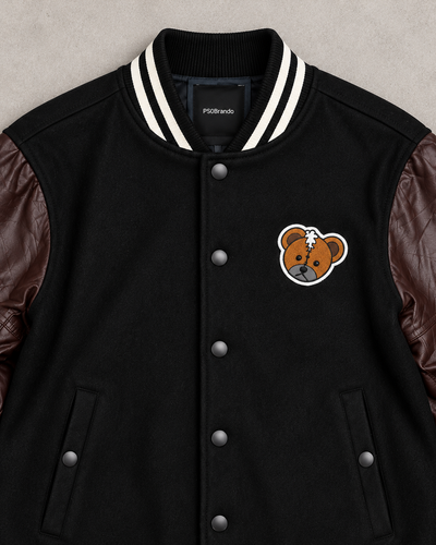 Close-up of bear chest patch, striped collar and snap buttons
